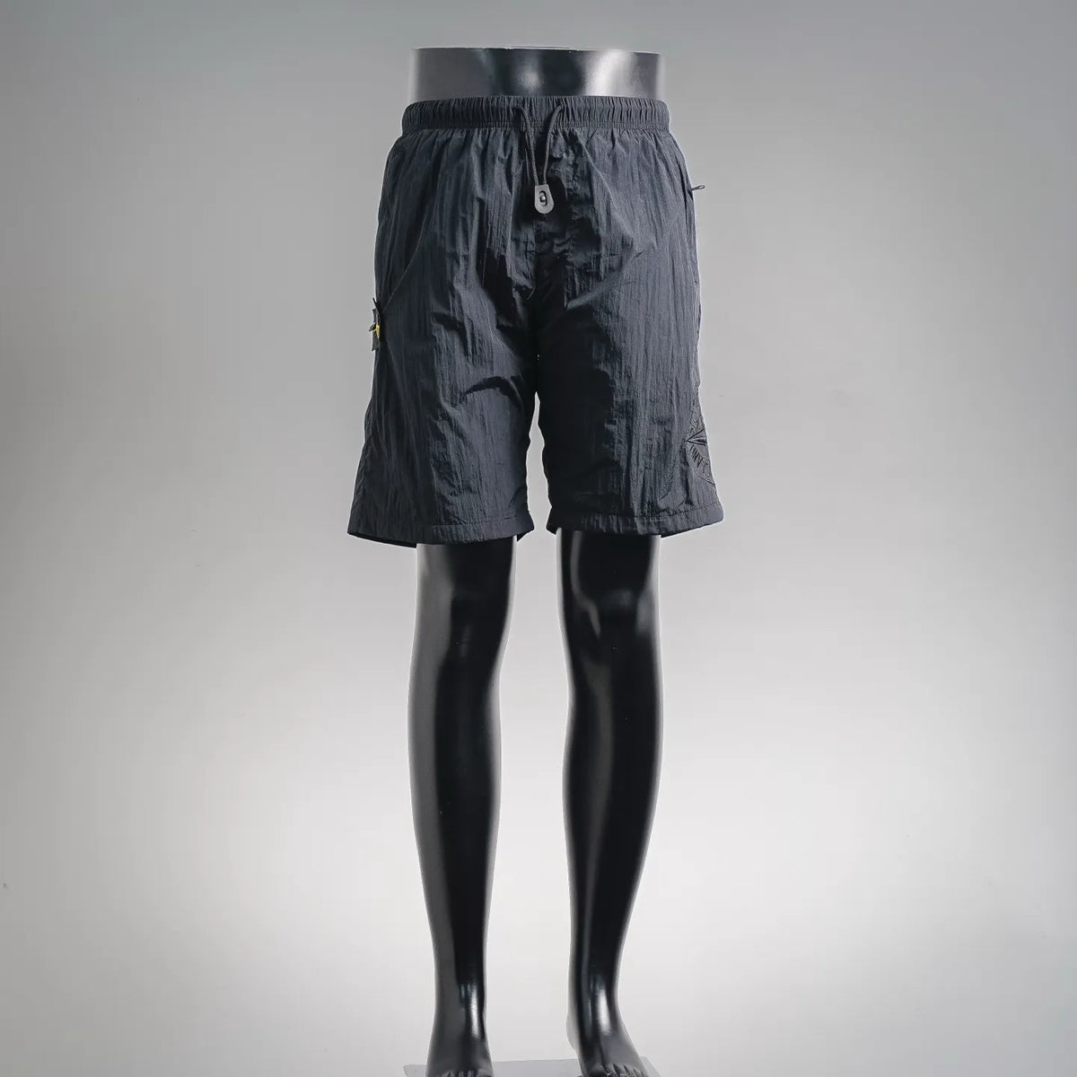 Stone Island dark shorts with elastic waistband and buttoned front pockets