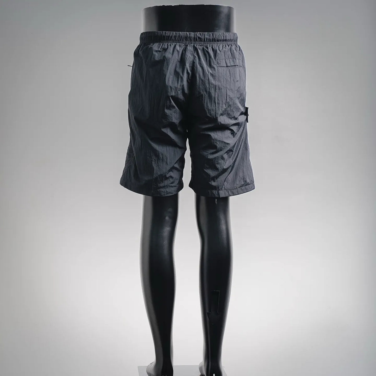 Stone Island dark shorts, back view, elastic waistband and side pocket openings