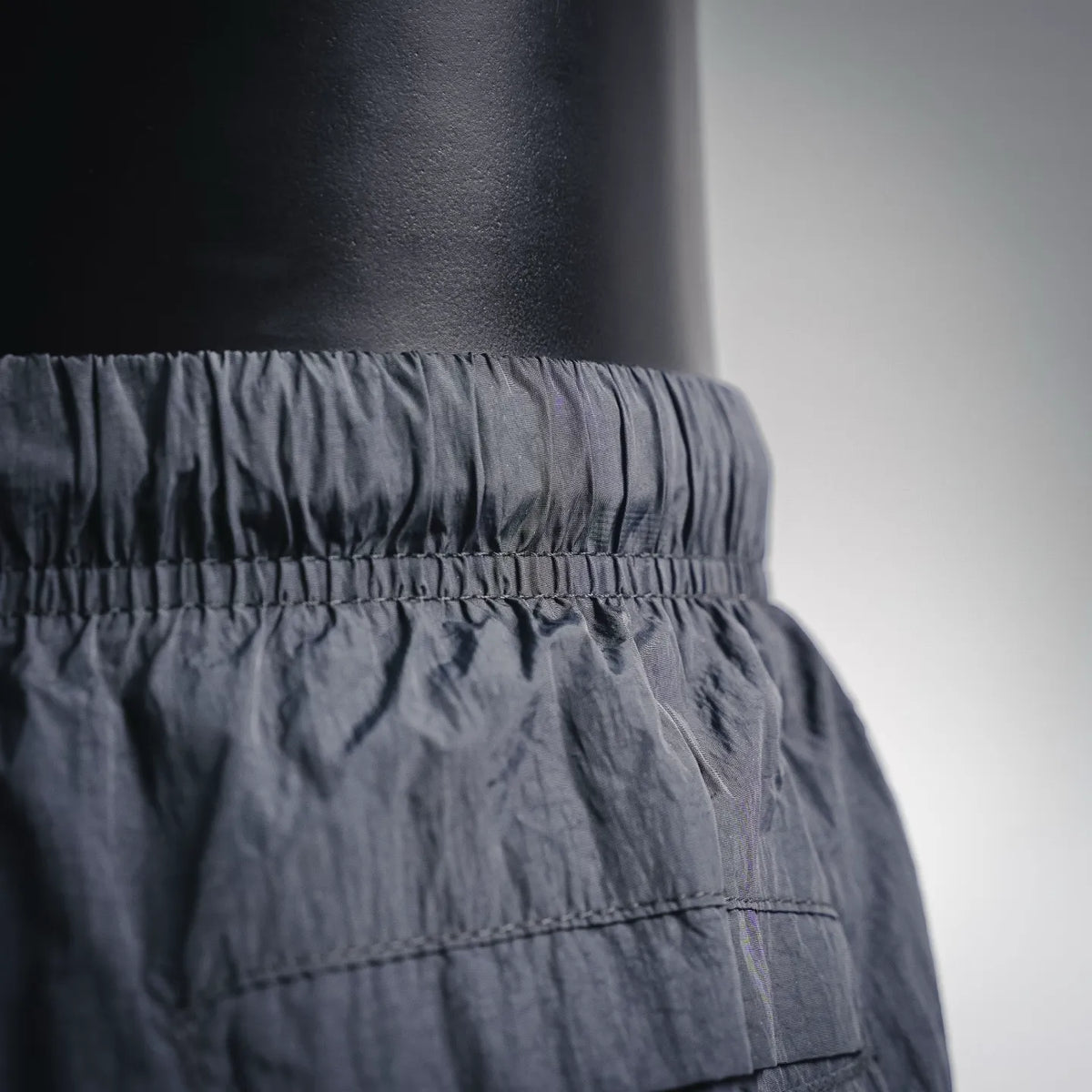 Stone Island dark shorts waistband detail with elastic gathers and seam