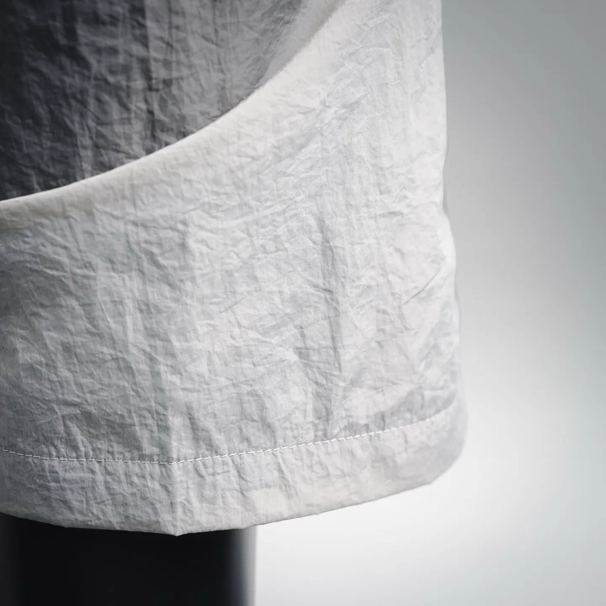 Stone Island shorts close-up of leg hem with stitched cuff and gathered fabric