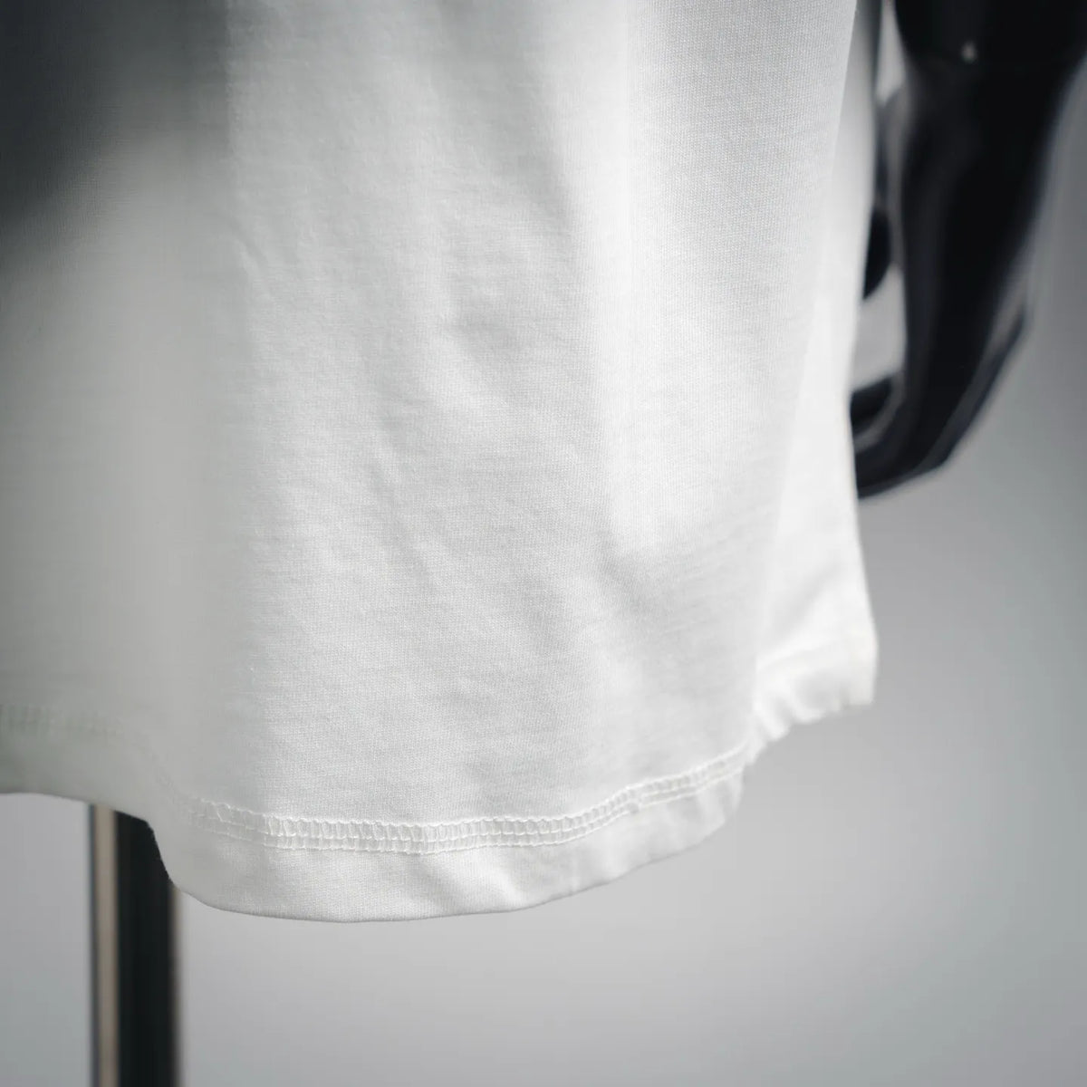 White T-shirt hem and stitching detail