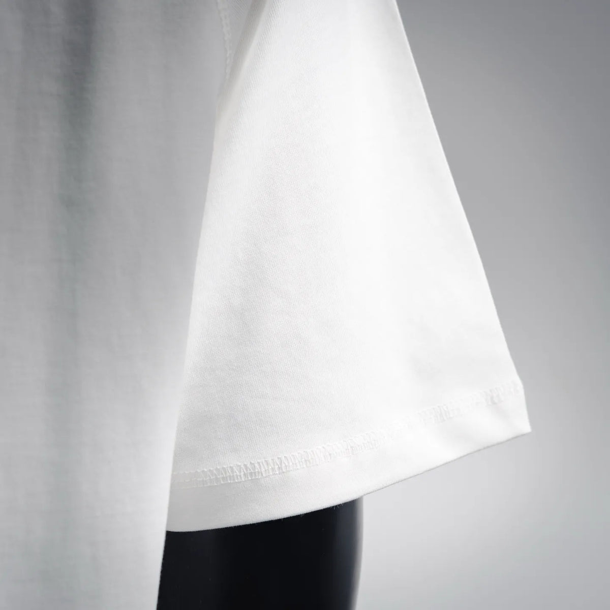White T-shirt side seam and curved lower hem