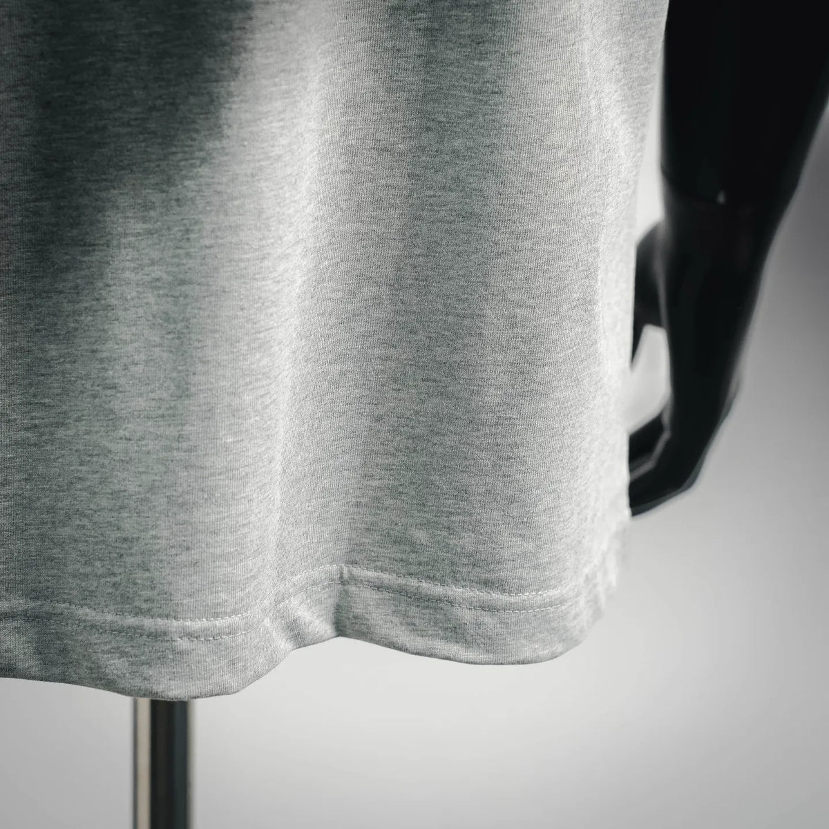 Light gray T-shirt hem and short sleeves seam detail