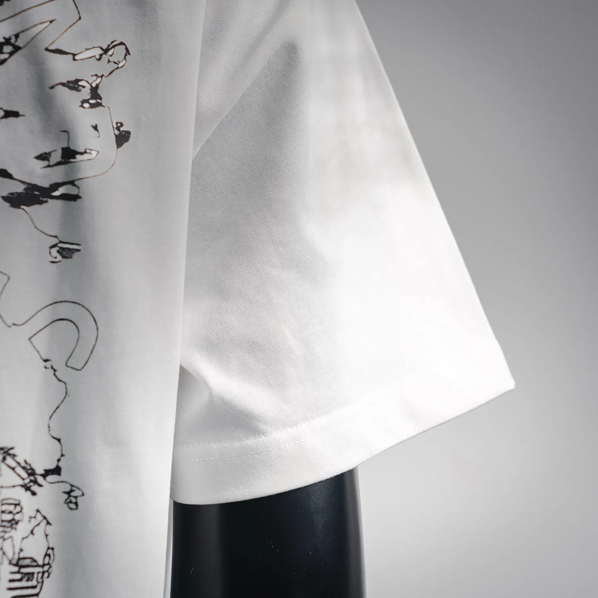Stone Island white short-sleeve T-shirt fabric close-up with curved hem