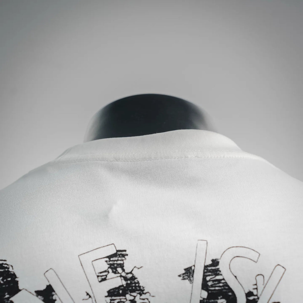 Stone Island T-shirt back neckline close-up with partial black graphic