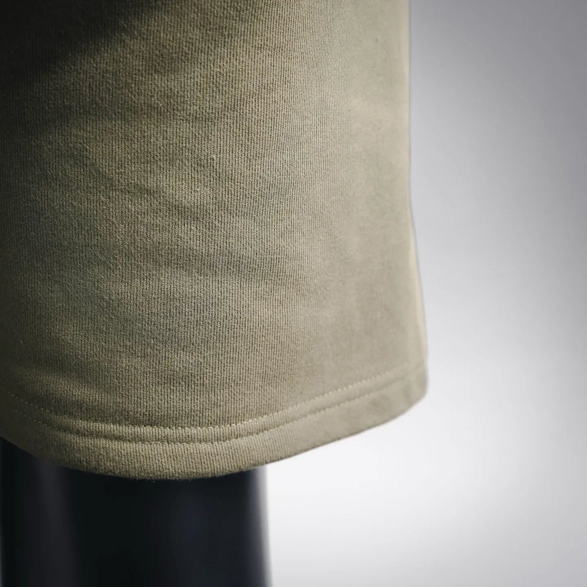 Stone Island olive-green shorts fabric close-up, knit texture