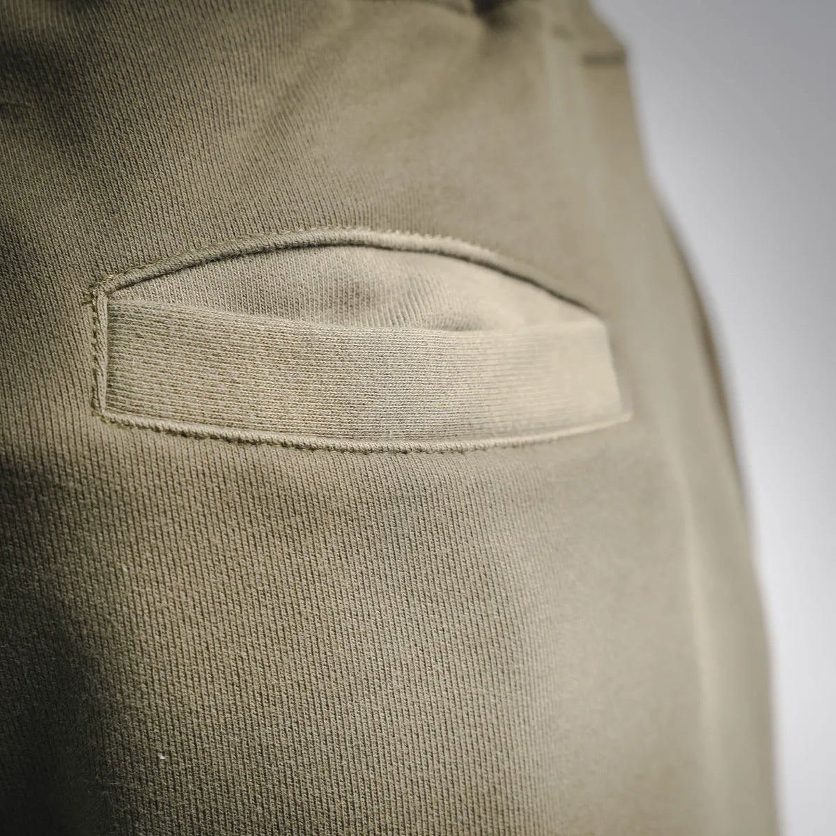 Stone Island olive-green shorts with stitched side pocket detail