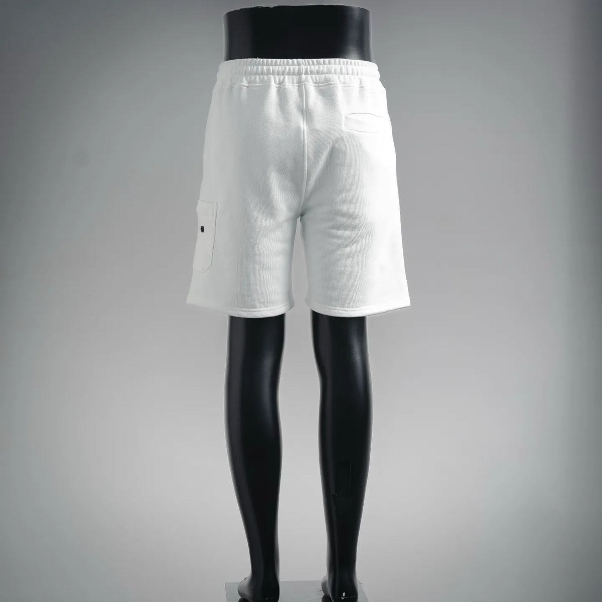 White shorts on a mannequin with side pocket and straight mid-thigh cut
