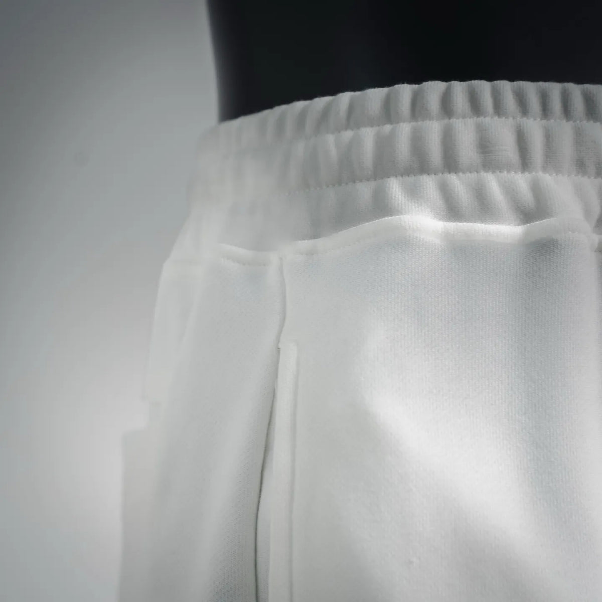 White shorts waistband with gathered elastic and smooth front panel