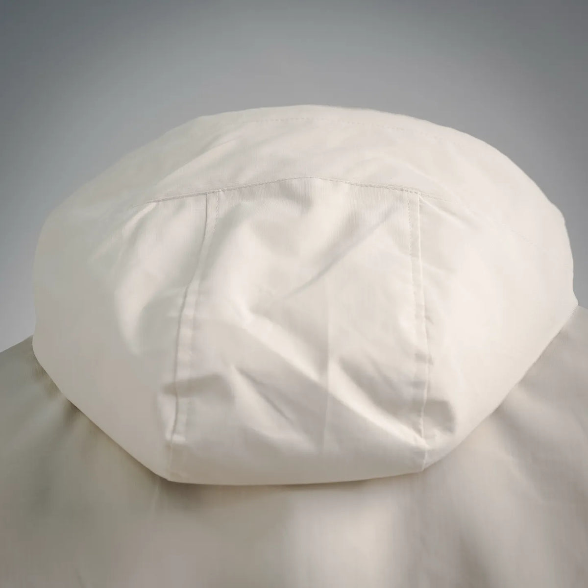 White hood with curved brim and visible seam stitching