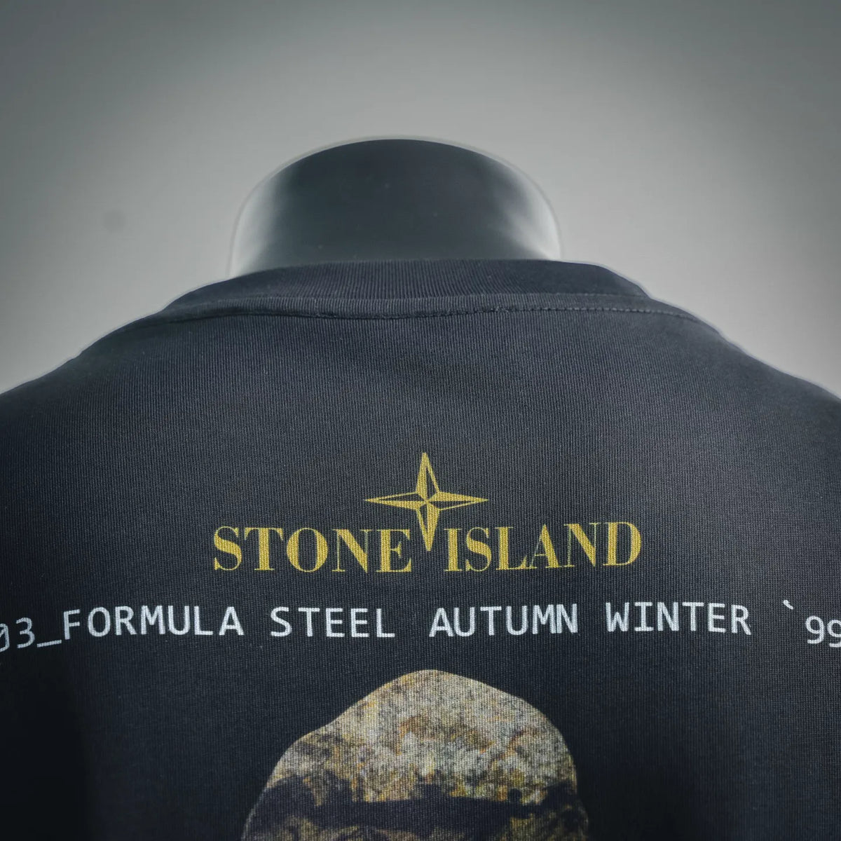 Graphic T-shirt back with Stone Island logo and yellow star over camo-style arched print