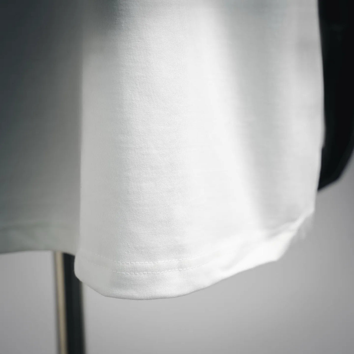 White crewneck T-shirt hem and waistband stitch detail