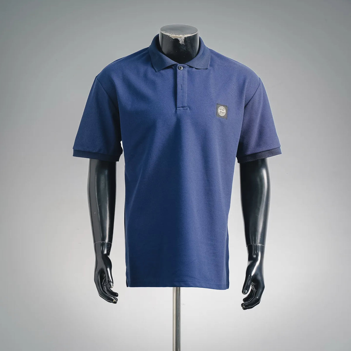 Stone Island blue polo shirt with button placket and chest logo patch
