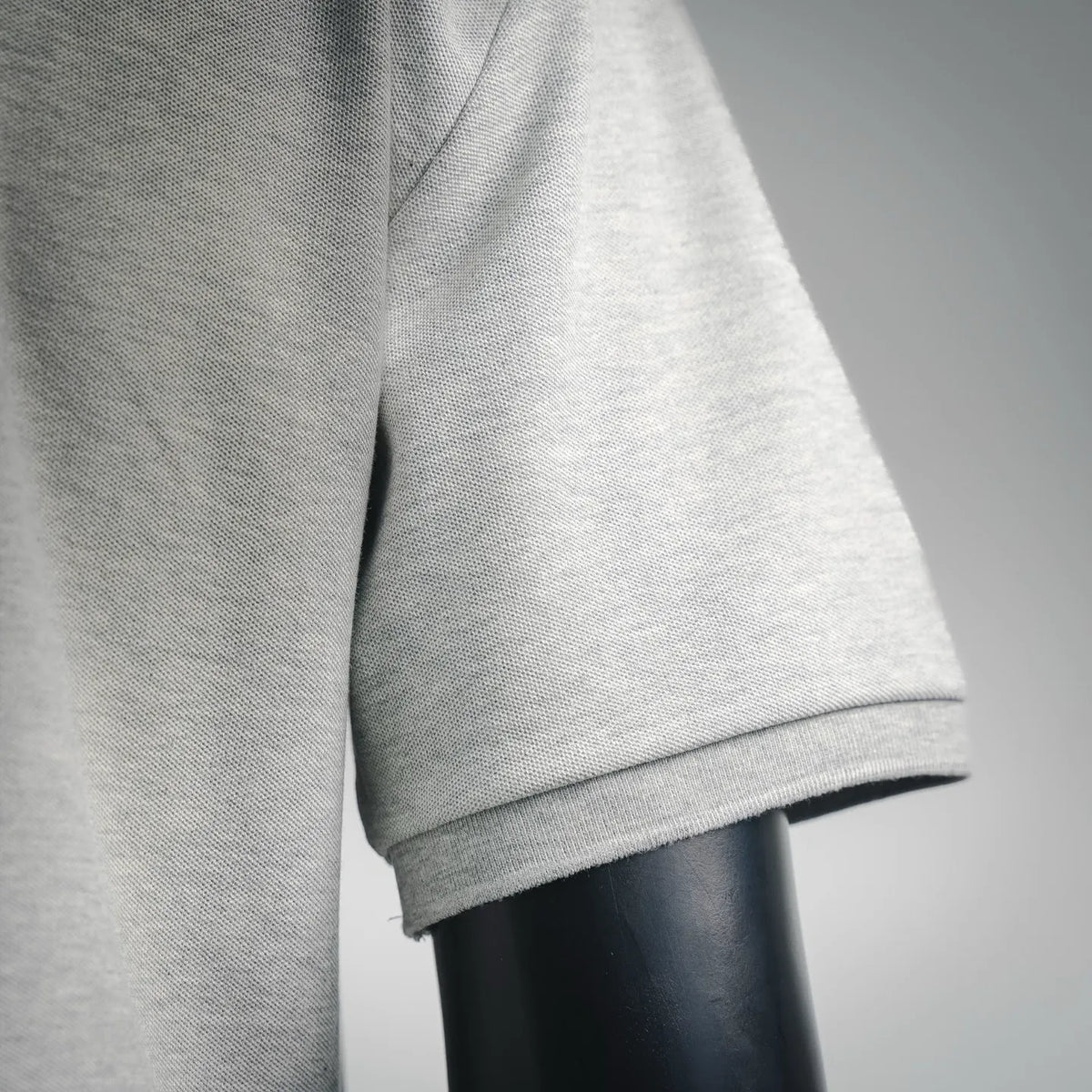 Light gray polo shirt sleeve hem and cuff with ribbed edging detail