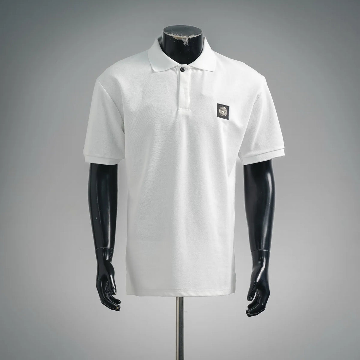 White short-sleeve polo shirt with button placket and chest logo patch