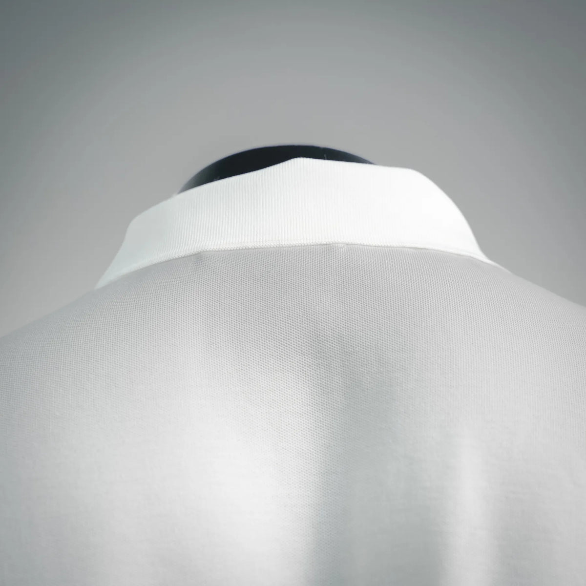 White polo shirt collar and upper back with smooth shoulder line