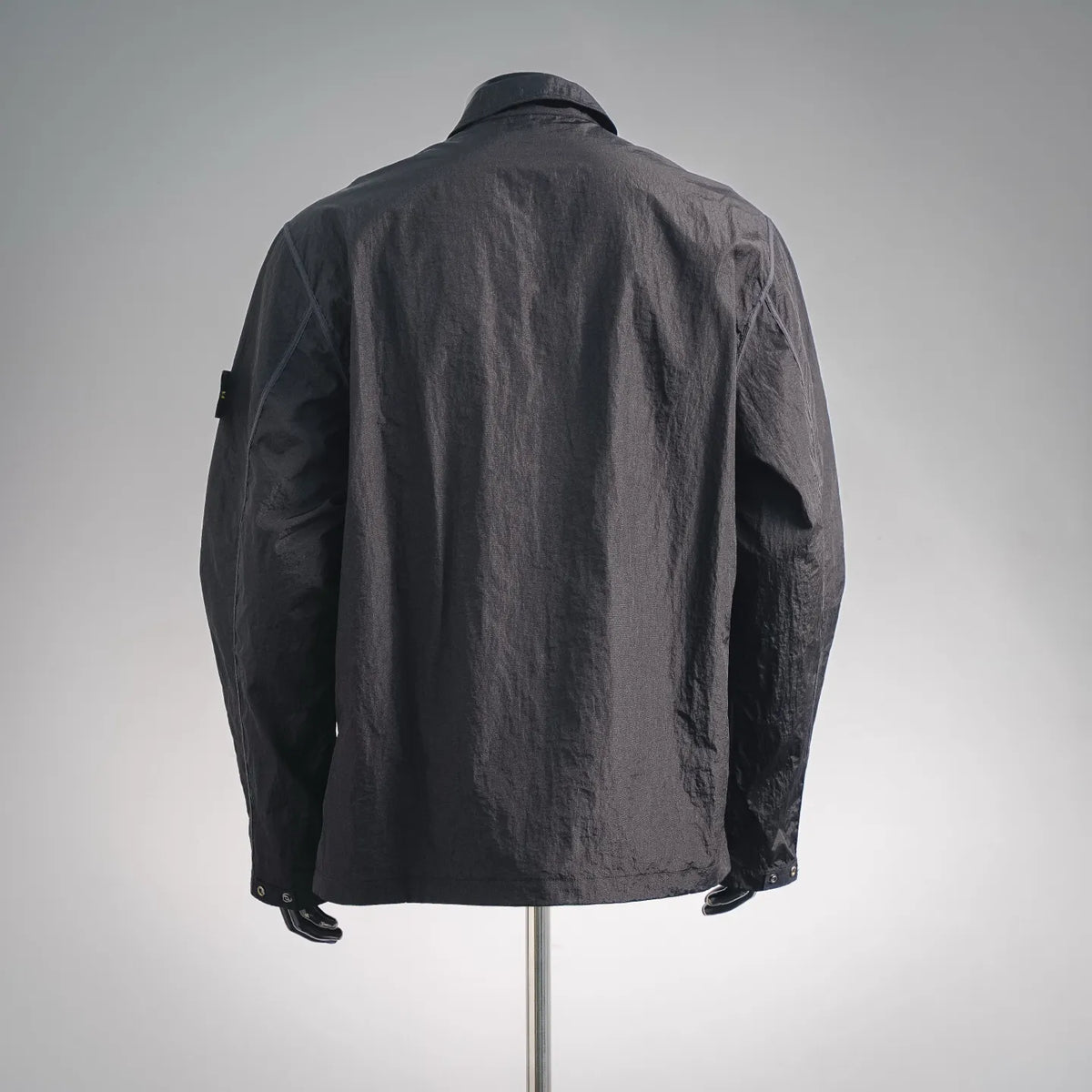 Men's Stone Island dark coat jacket, stand collar, back view with relaxed fit.
