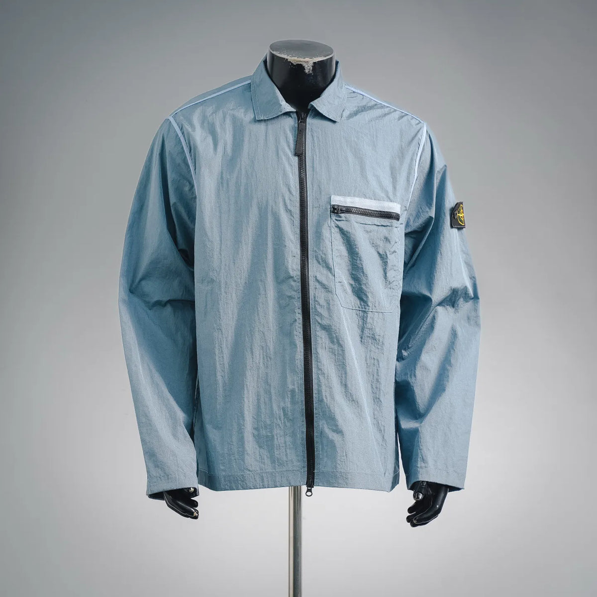 Light blue Stone Island coat with full zip front and chest pocket