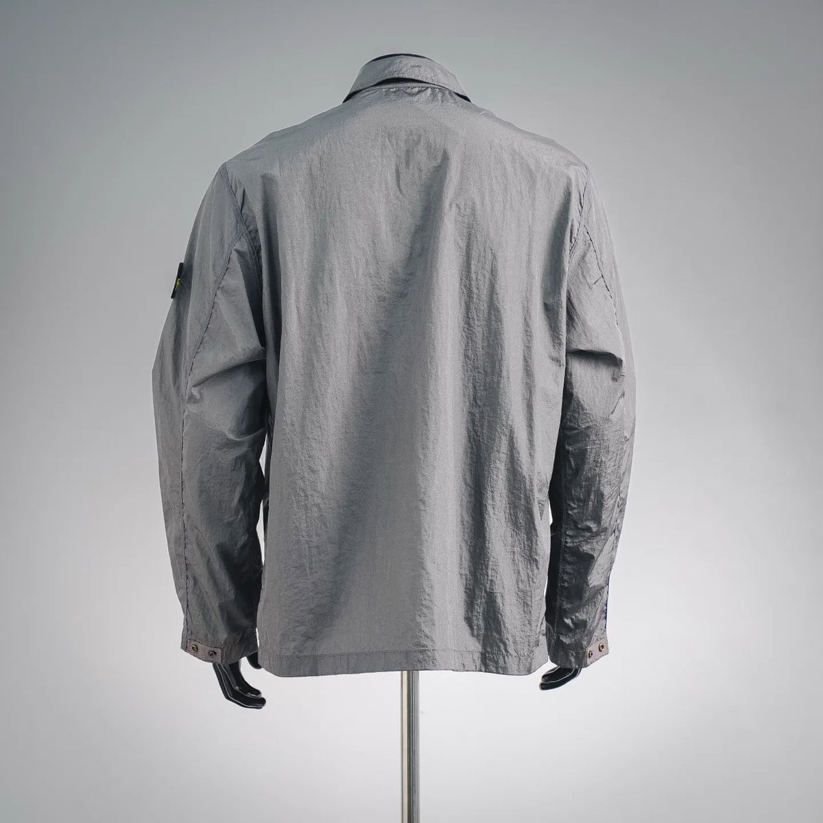 Stone Island coat in gray, back view with top collar and sleeve patch detail