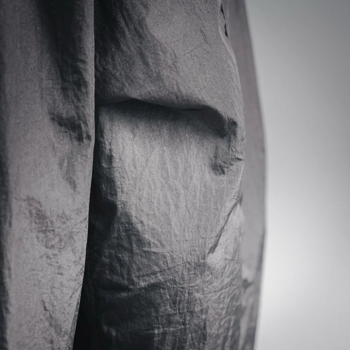 Stone Island coat fabric close-up in gray with stitched panel texture