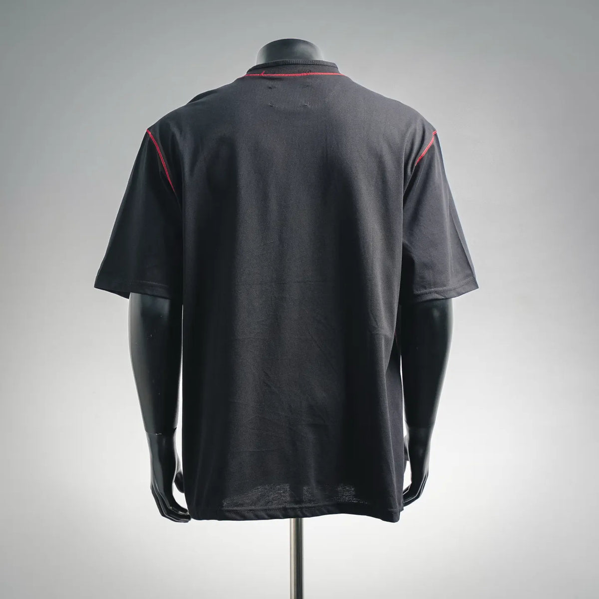 Black short-sleeve T-shirt with red-trim neckline and rear circular logo