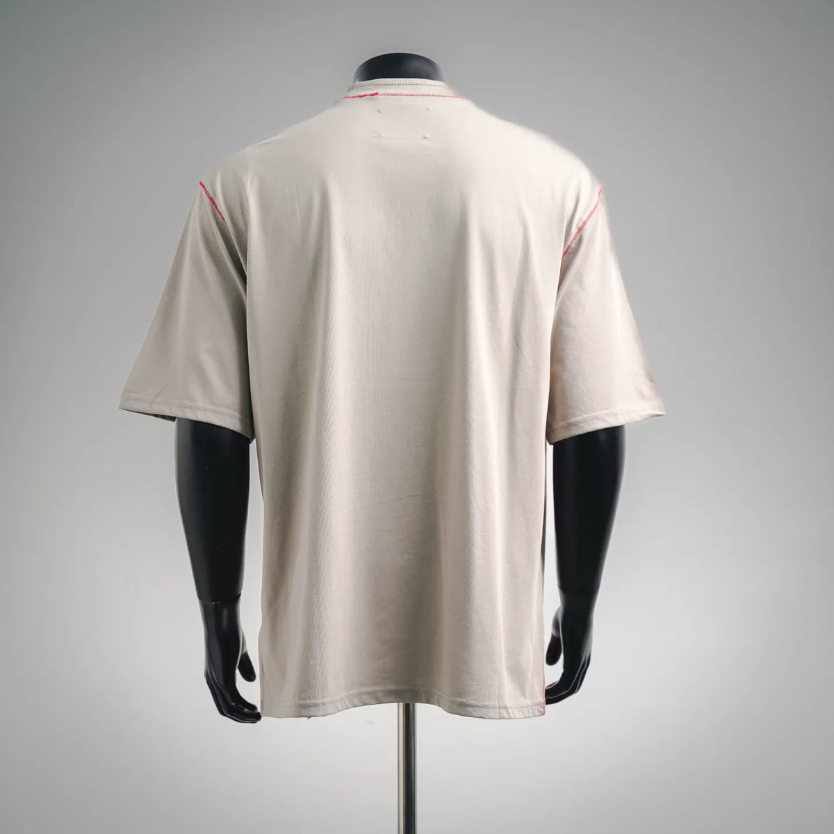 Light beige T-shirt back view with red collar piping