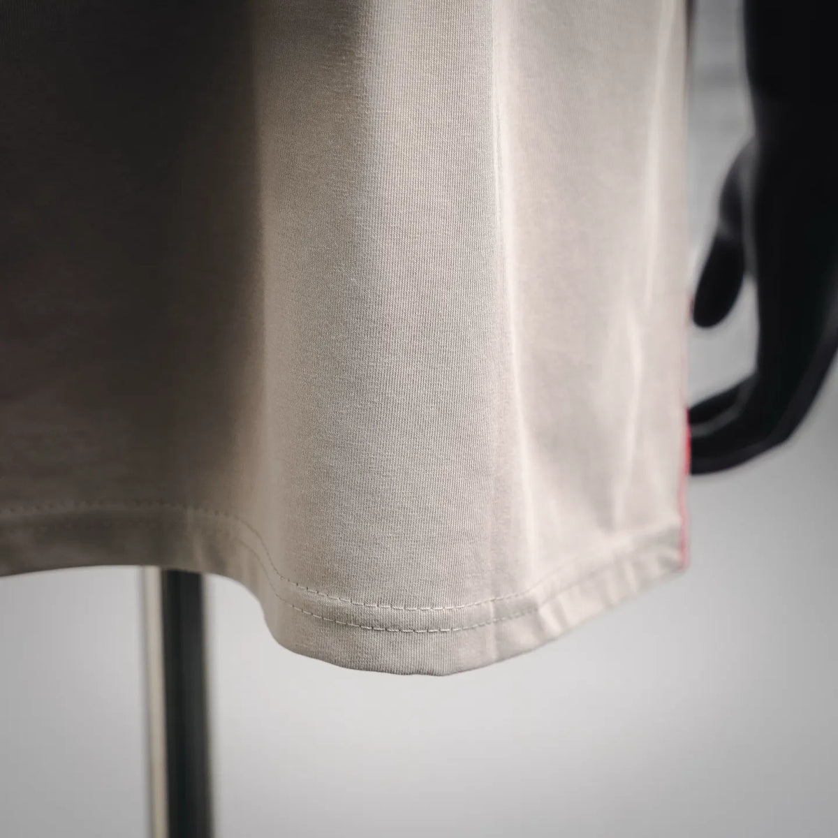 Light beige T-shirt sleeve hem with stitched edge