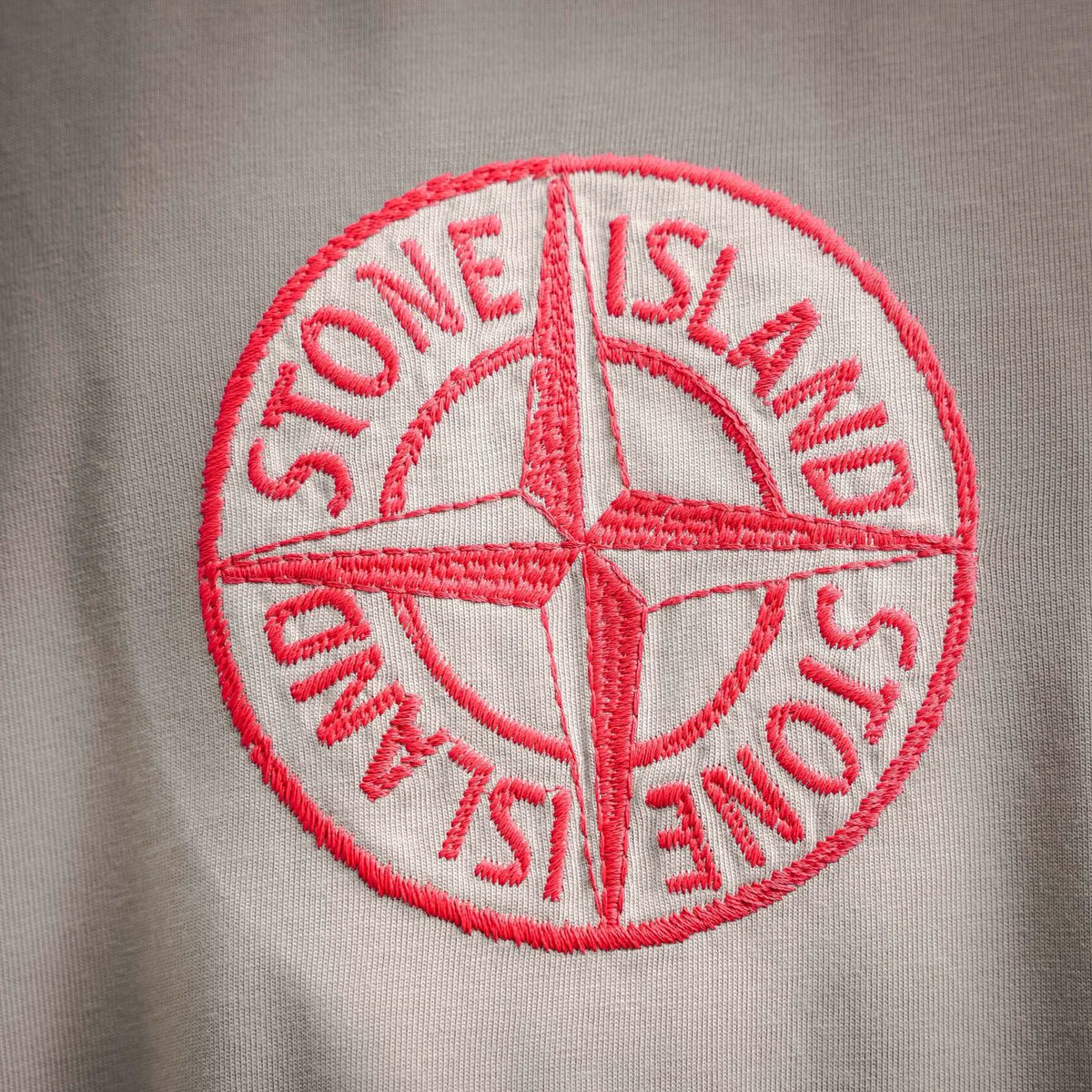Stone Island red embroidered circular logo on light beige T-shirt