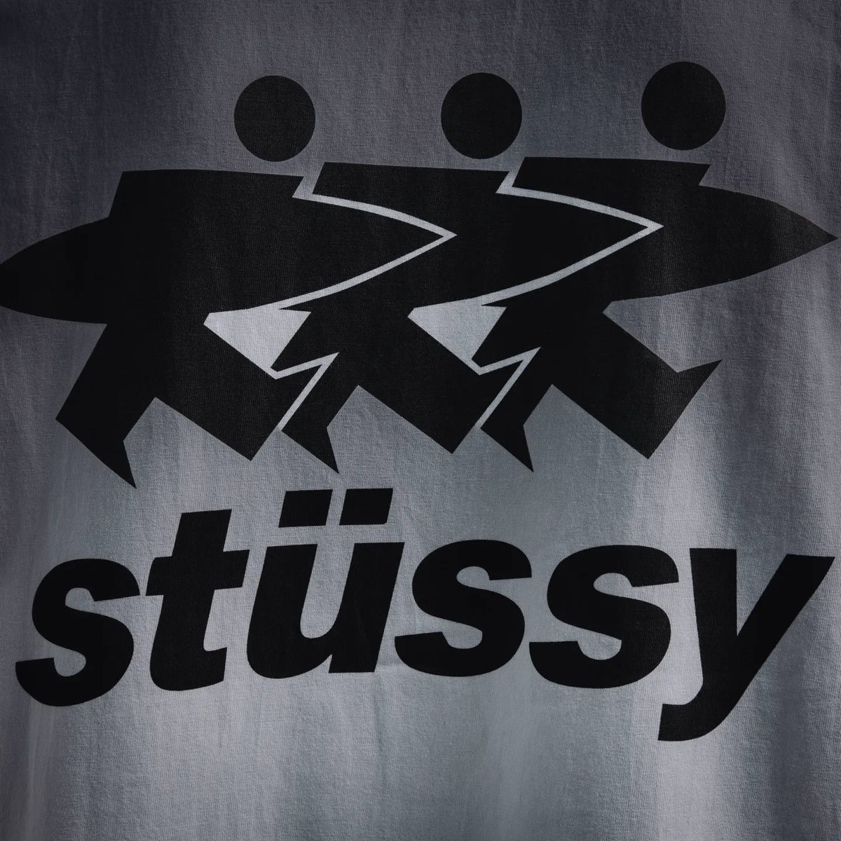 Close-up of black Stussy graphic on white T-shirt
