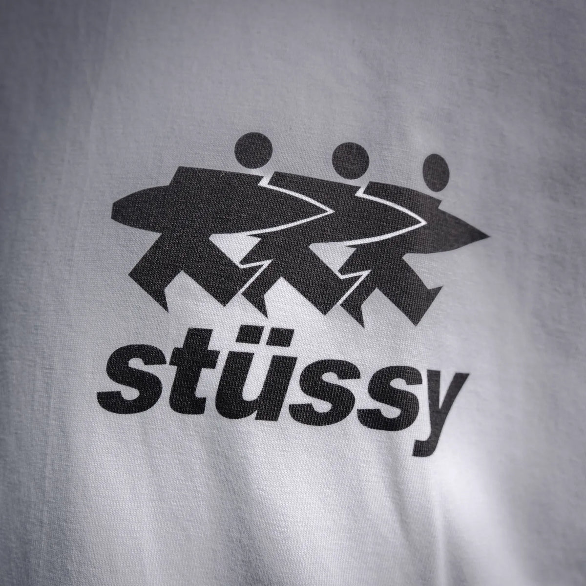 White Stussy short-sleeve T-shirt with large front graphic and text