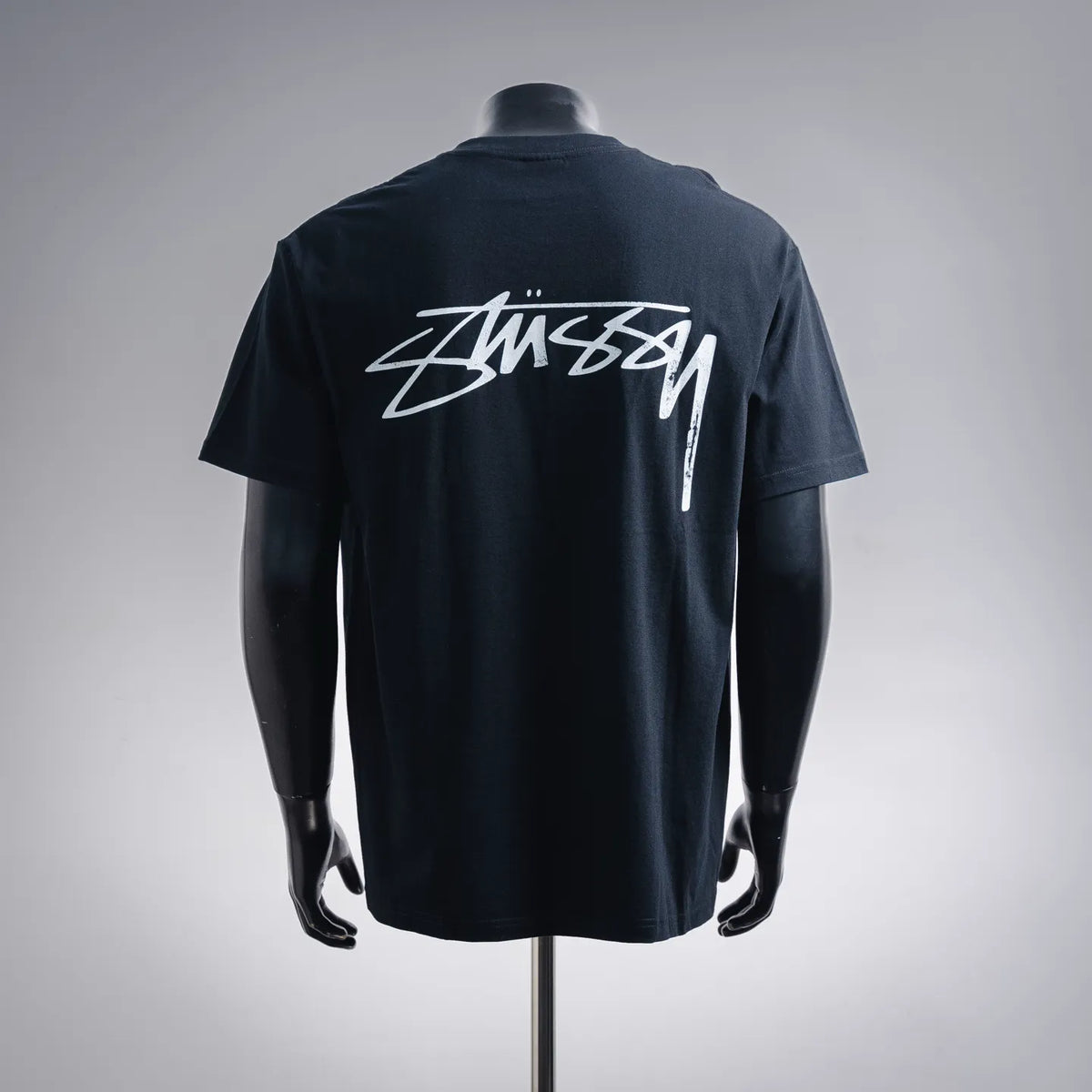 Stussy crewneck T-shirt in dark navy with Stussy logo graphic on the back
