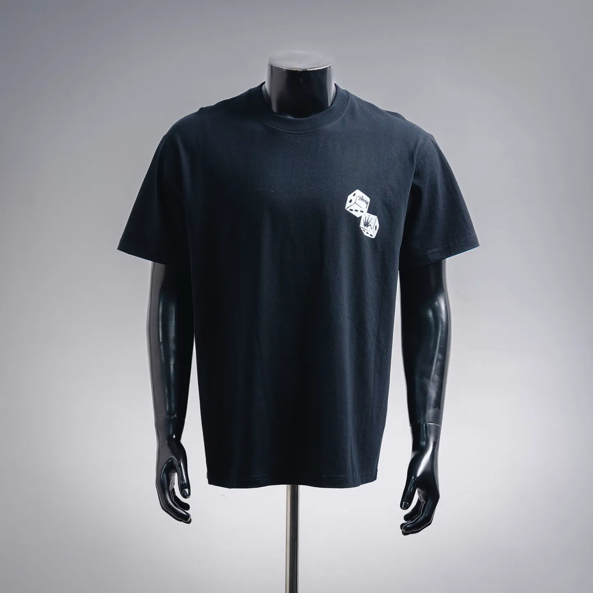 Black Stussy short-sleeve T-shirt with small dice graphic at left chest
