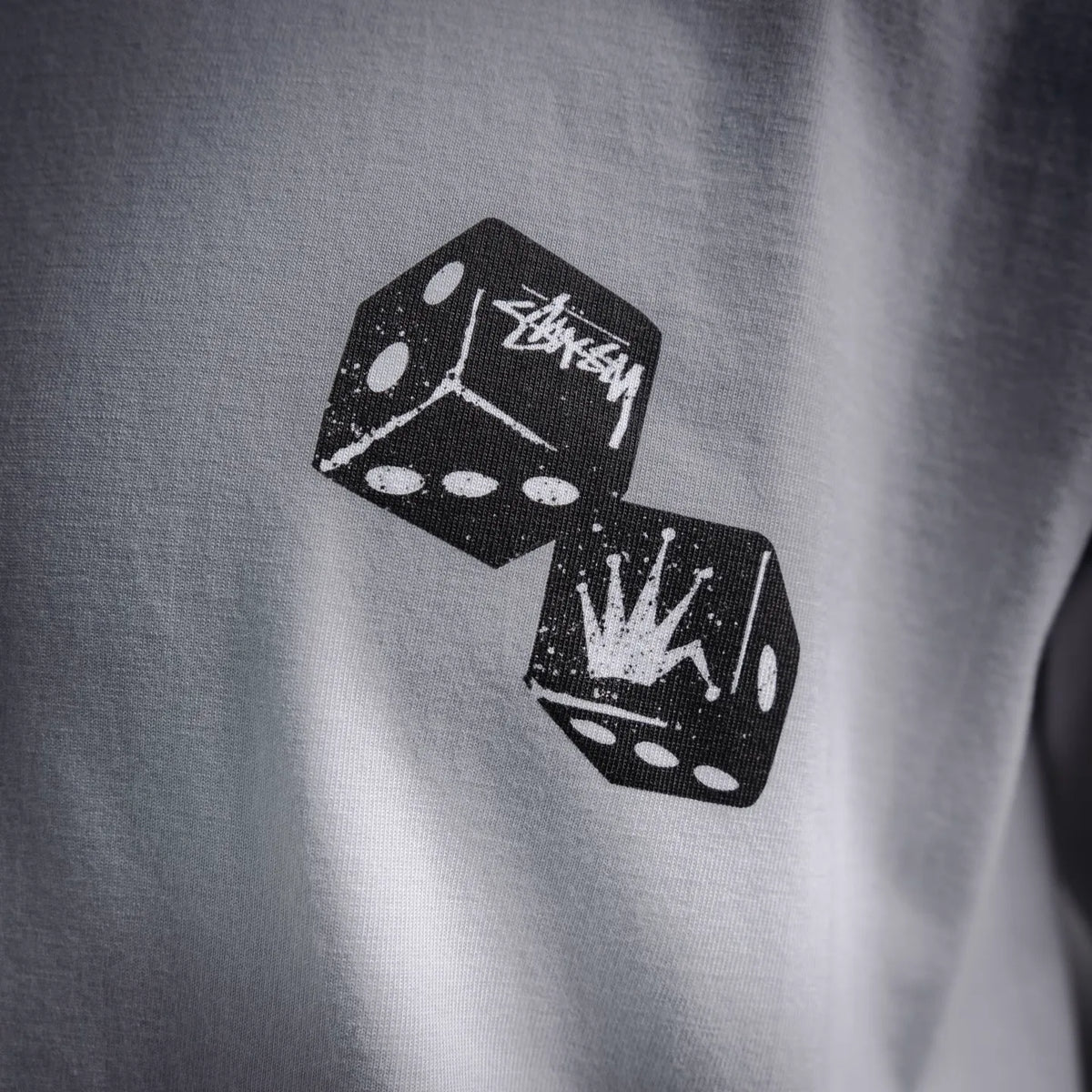 Close-up of black dice-style graphic print on white T-shirt