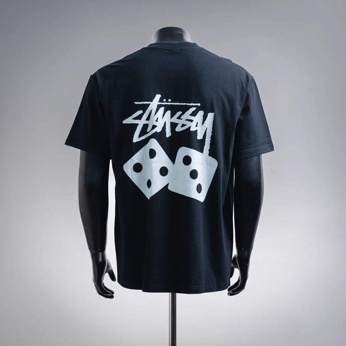 Black short-sleeve T-shirt with large white Stussy dice graphic on back