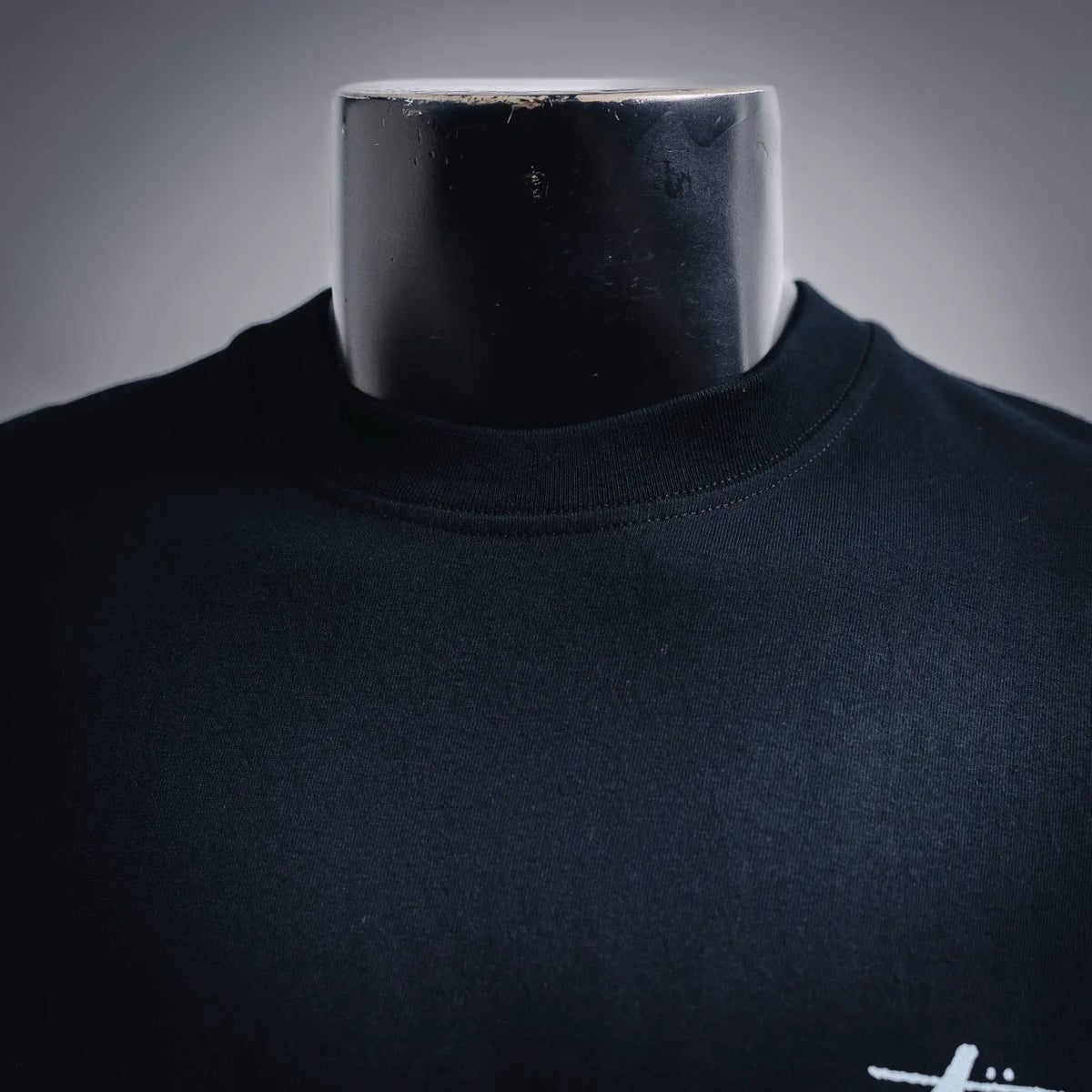 Black short-sleeve T-shirt neckline with small white Stussy logo detail