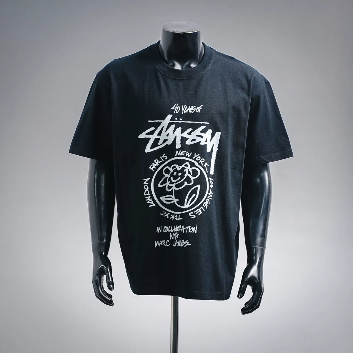 Stussy graphic T-shirt with round neckline, short sleeves, and white front logo art