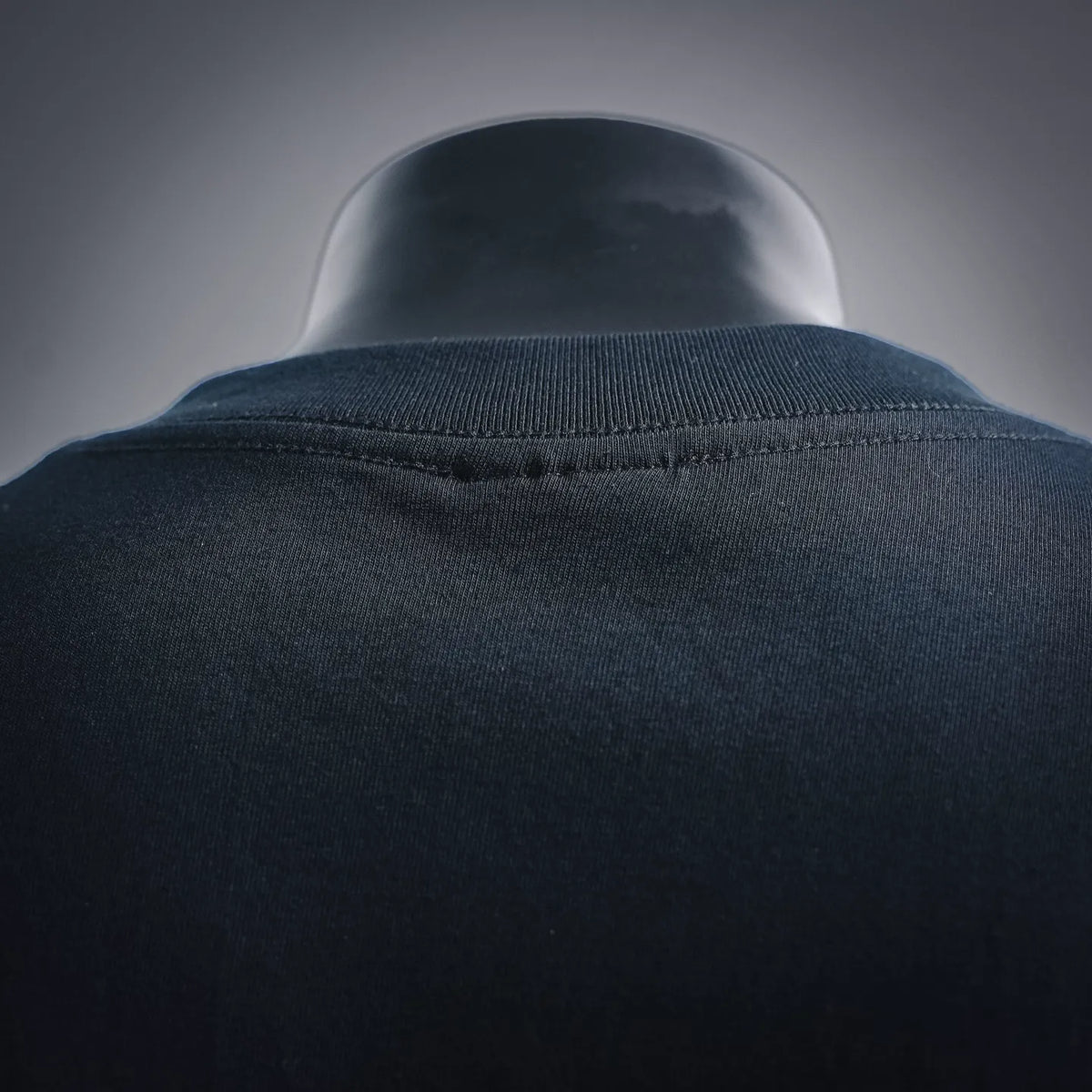 Stussy T-shirt collar close-up with ribbed crew neck and dark fabric