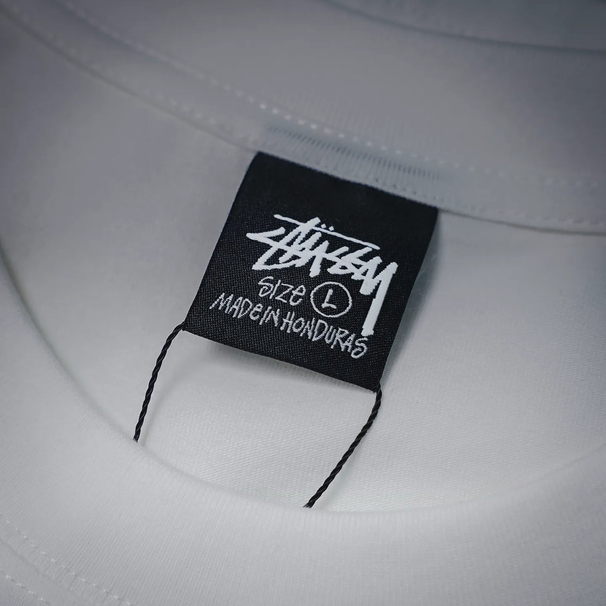 White T-shirt collar with black brand size tag