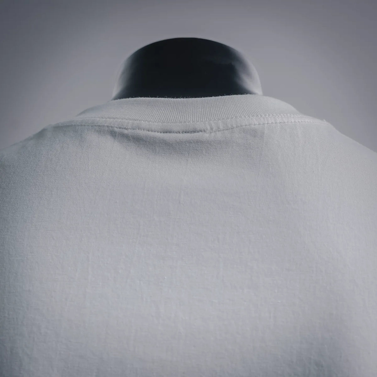 White crew-neck T-shirt with ribbed collar close-up