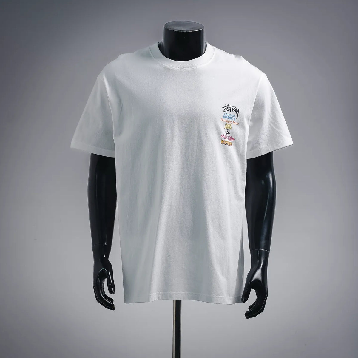 White crew-neck T-shirt with small chest graphic print and multicolor logo