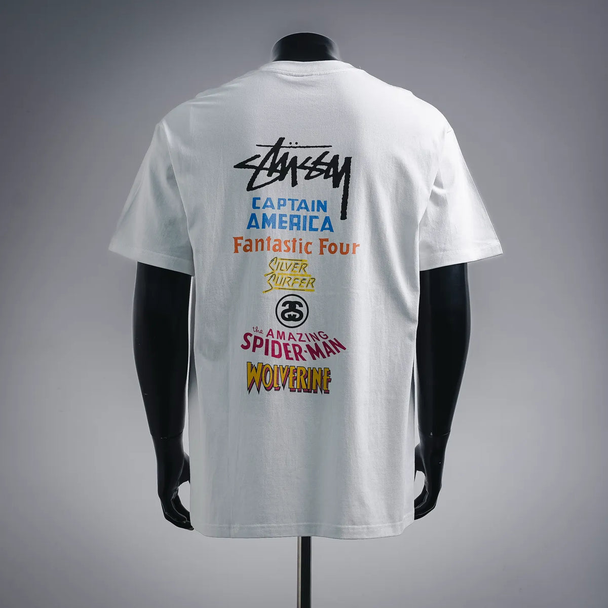 White crew-neck T-shirt with large back graphic text and multicolor characters