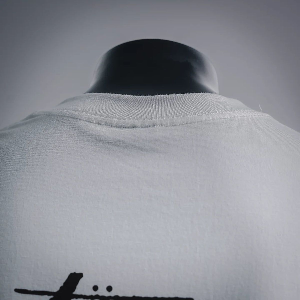 White crew-neck T-shirt collar seam close-up, soft knit fabric