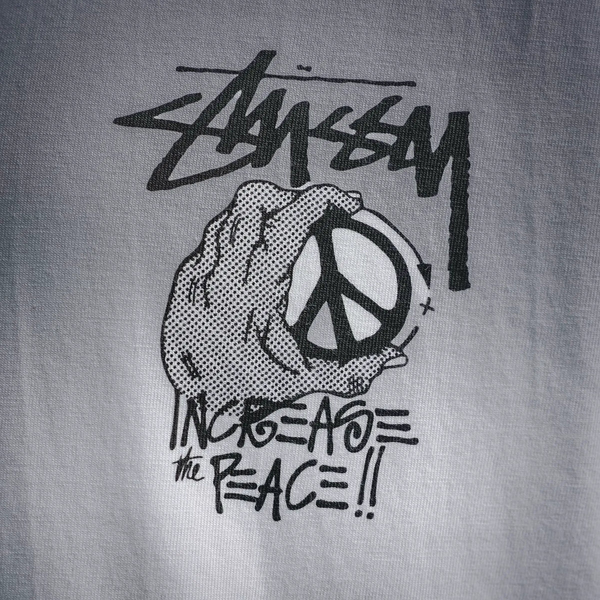 White short-sleeve T-shirt with back peace hand graphic detail