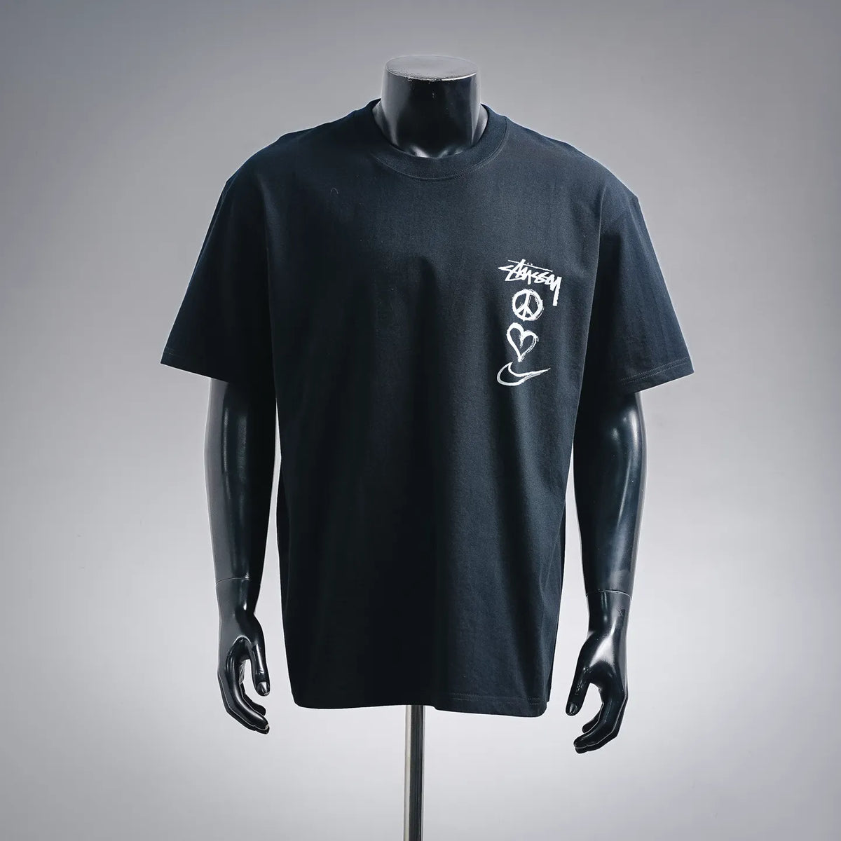 Black Stussy graphic T-shirt with crew neck and short sleeves, front logo print