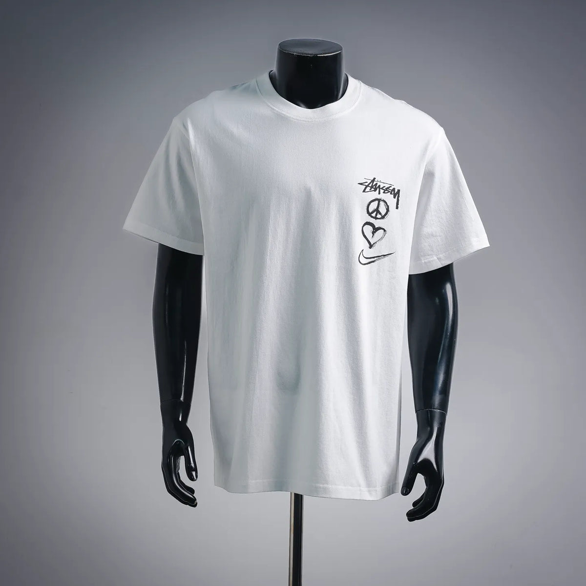 White short-sleeve crewneck T-shirt with small Stussy graphic on chest