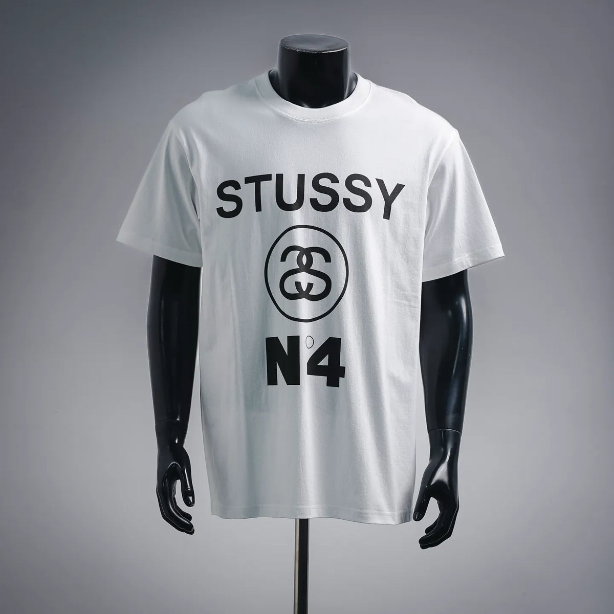 White Stussy N°4 graphic T-shirt on a mannequin, short sleeves