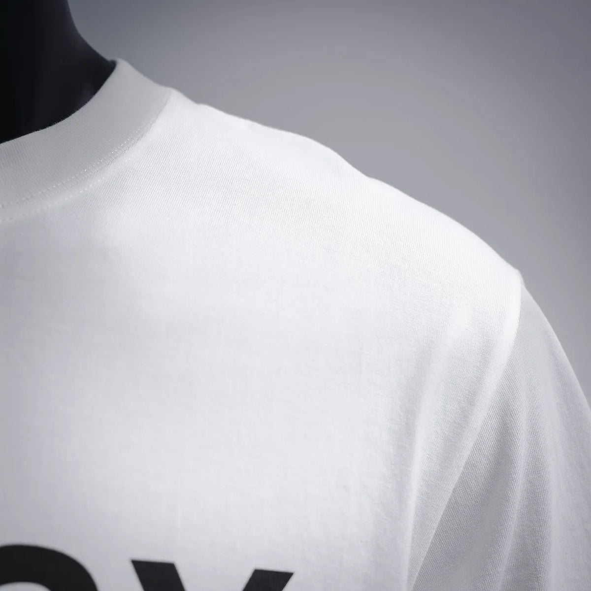 White T-shirt fabric close-up at shoulder and side seam