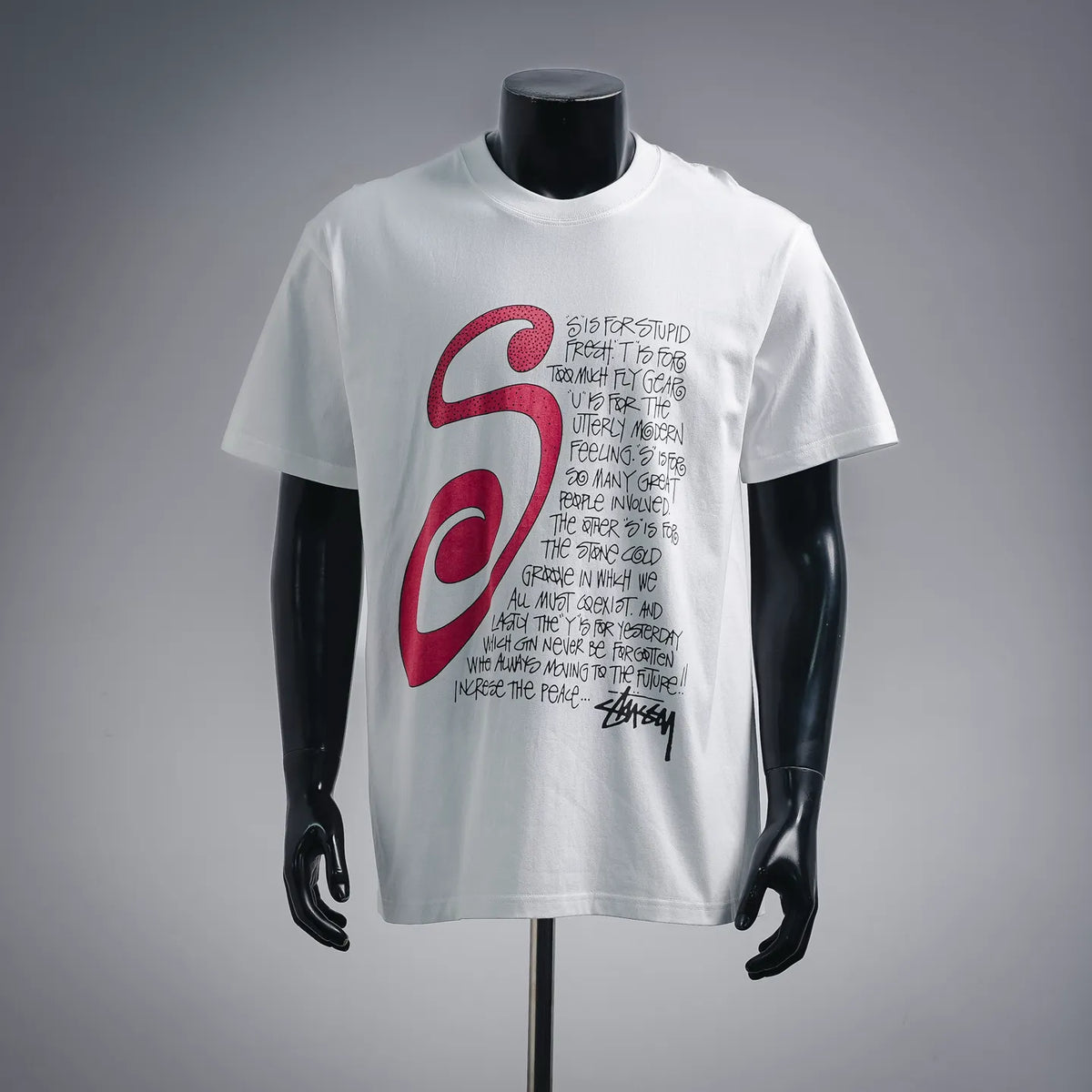 Stussy white short-sleeve T-shirt with large red S graphic and handwritten text