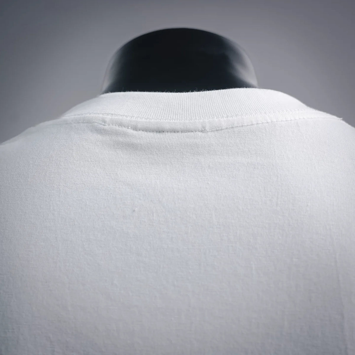 Stussy white short-sleeve T-shirt back neckline close-up