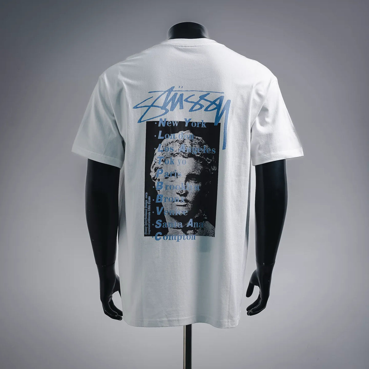 Stussy white short-sleeve T-shirt with large back graphic and city list